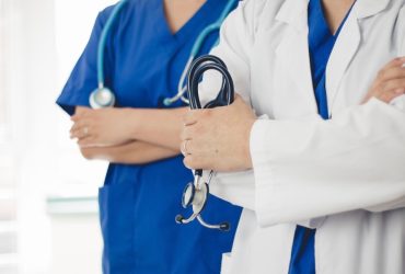 Doctors with stethoscopes in uniform.