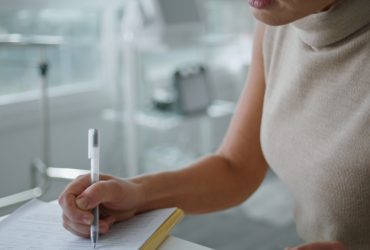 Doctor signing a contract.